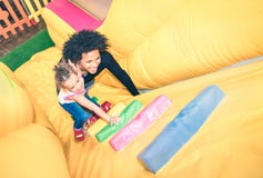 Latin american dad playing with mixed race daughter at playroom Stock Photo Latin american dad playing with mixed race daughter at playroom Stock Photo
