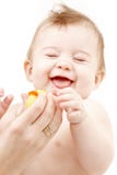 Laughing baby boy in mother hands with rubber duck