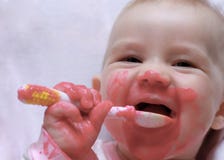 Laughing Baby With A Spoon In The Mouth Stock Photos