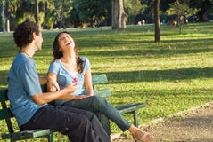 Laughing Couple On A Park Bench - Horizontal Royalty Free Stock Image