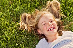 Laughing girl lying in grass