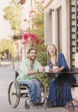 Laughing Woman and Man in Wheelchair Outdoors Stock Images Laughing Woman and Man in Wheelchair Outdoors Stock Images