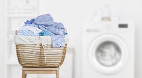 Laundry basket on blurred background of modern washing machine
