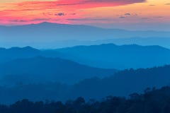 Layer of mountains in the mist at sunset time with burning sky, stock photography Layer of mountains in the mist at sunset time with burning sky, stock photography
