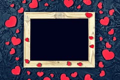 Valentine`s Day. Layout for the postcard. Wooden frame blank and hearts on a black stone background royalty free stock photo Valentine`s Day. Layout for the postcard. Wooden frame blank and hearts on a black stone background royalty free stock photo