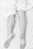 Lazy man happy waking up in the bed rising hands in the morning with fresh feeling relaxed. Handsome man using clock in royalty free stock image Lazy man happy waking up in the bed rising hands in the morning with fresh feeling relaxed. Handsome man using clock in royalty free stock image