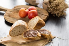 Le baguette del pane francese hanno tagliato sul bordo di legno con il coltello con un cho immagini stock libere da diritti Le baguette del pane francese hanno tagliato sul bordo di legno con il coltello con un cho immagini stock libere da diritti