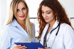 Le den härliga kvinnliga medicindoktorn förklara diagnosen arkivbild Le den härliga kvinnliga medicindoktorn förklara diagnosen arkivbild