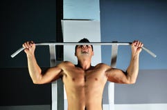Le jeune homme avec fait violence l'élaboration en gymnastique photos stock Le jeune homme avec fait violence l'élaboration en gymnastique photos stock