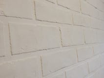 Le mur de fond de ce plâtre blanc de brique images stock Le mur de fond de ce plâtre blanc de brique images stock