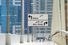 Le panneau routier indiquant la direction de Dubaï et d'Abu Dhabi, le choix doit être fait à la prochaine intersection image stock Le panneau routier indiquant la direction de Dubaï et d'Abu Dhabi, le choix doit être fait à la prochaine intersection image stock