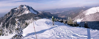 Le randonneur va vers le bas des montagnes congelées photo libre de droits Le randonneur va vers le bas des montagnes congelées photo libre de droits