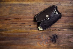 Leather key case with keys on the wood background. Dark background. Keychain. Key case in the form of a vest royalty free stock photography Leather key case with keys on the wood background. Dark background. Keychain. Key case in the form of a vest royalty free stock photography