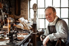Leather worker at Blists Hill Victorian Museum. TELFORD, UK - CIRCA 2013: Leather worker at Blists Hill Victorian Museum, Ironbridge, UK stock photo Leather worker at Blists Hill Victorian Museum. TELFORD, UK - CIRCA 2013: Leather worker at Blists Hill Victorian Museum, Ironbridge, UK stock photo