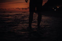 Leg portrait. A young guy trains on the beach. - concept about people, lifestyle and sport. A boy stand. silhouette stock photo Leg portrait. A young guy trains on the beach. - concept about people, lifestyle and sport. A boy stand. silhouette stock photo