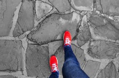 Legs in sneakers make a step on the pavement. stock photos Legs in sneakers make a step on the pavement. stock photos