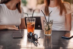 Leisure, holidays, eating, people and food concept - happy friends having dinner at summer garden party and clinking drinks stock photos Leisure, holidays, eating, people and food concept - happy friends having dinner at summer garden party and clinking drinks stock photos