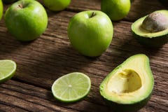 Lemon slice, avocado and green apple arranged on wooden table stock photography Lemon slice, avocado and green apple arranged on wooden table stock photography