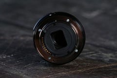 Zoom lens. bayonet lens. on a wooden background stock photos Zoom lens. bayonet lens. on a wooden background stock photos