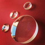 Lenses on a red background Royalty Free Stock Photography Lenses on a red background Royalty Free Stock Photography