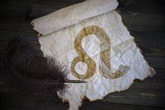 Leo sign of the zodiac on vintage paper with old pen on the wooden desk Stock Photography Leo sign of the zodiac on vintage paper with old pen on the wooden desk Stock Photography