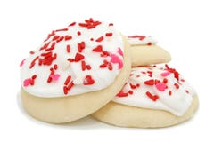 Les biscuits avec le givrage et le coeur blancs arrose photographie stock Les biscuits avec le givrage et le coeur blancs arrose photographie stock