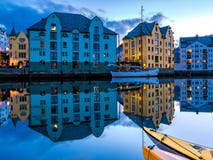 Les bâtiments et les bateaux norvégiens se sont reflétés dans un canal tranquille dans Alesund, la ville la plus belle dans la cô image stock Les bâtiments et les bateaux norvégiens se sont reflétés dans un canal tranquille dans Alesund, la ville la plus belle dans la cô image stock