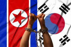 Les mains des chaînes dans la perspective du drapeau de la Corée du Nord, DPRK, Corée du Sud photo libre de droits Les mains des chaînes dans la perspective du drapeau de la Corée du Nord, DPRK, Corée du Sud photo libre de droits