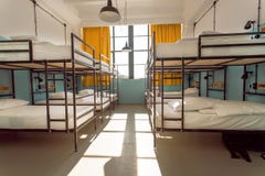 Les randonneurs restent dans l'hôtel avec les lits modernes d'autobus à impériale à l'intérieur de la salle de dortoir pour douze Photo stock Les randonneurs restent dans l'hôtel avec les lits modernes d'autobus à impériale à l'intérieur de la salle de dortoir pour douze Photo stock