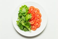 Lettuce and tomatoes over white plate Royalty Free Stock Images Lettuce and tomatoes over white plate Royalty Free Stock Images