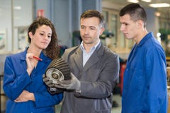 Leute, die mechanisches Teil betrachten stockfotos Leute, die mechanisches Teil betrachten stockfotos
