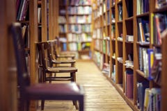 Library with books on shelf and empty chairs Royalty Free Stock Photos Library with books on shelf and empty chairs Royalty Free Stock Photos