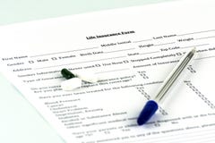 Life insurance form. A few pills and a pen on the sheet. stock images Life insurance form. A few pills and a pen on the sheet. stock images