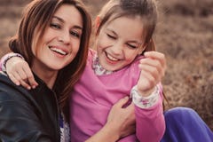Lifestyle capture of happy mother and preteen daughter having fun outdoor. Loving family spending time together on the walk. stock image Lifestyle capture of happy mother and preteen daughter having fun outdoor. Loving family spending time together on the walk. stock image
