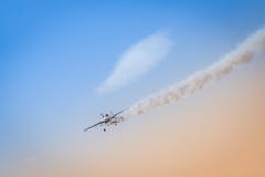 Light aeroplane flies down leaving behind itself a dark smoke as an illustration of crash of private jet royalty free stock photos Light aeroplane flies down leaving behind itself a dark smoke as an illustration of crash of private jet royalty free stock photos