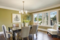 Light Olive Dining Room Features A Wood Carved Dining Table Stock