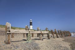 Lighthouse And Beach Groynes Royalty Free Stock Image