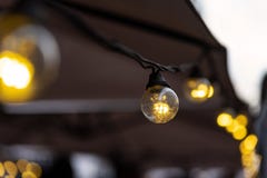 Lighting from small light bulbs in a summer cafe stock images Lighting from small light bulbs in a summer cafe stock images