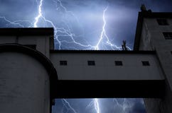Lightning and thunder on stormy summer night over factory Stock Photo Lightning and thunder on stormy summer night over factory Stock Photo