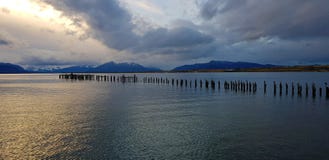 Lights of the sunset over the remains of the pier, Puerto Natales, Chile royalty free stock photos Lights of the sunset over the remains of the pier, Puerto Natales, Chile royalty free stock photos