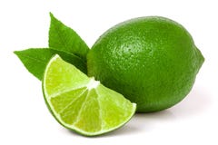 Lime with slices and leaf isolated on white background stock image Lime with slices and leaf isolated on white background stock image
