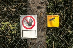 Linked wire fence with Keep out` and `Video surveillance` signs royalty free stock photos Linked wire fence with Keep out` and `Video surveillance` signs royalty free stock photos