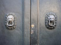 Lion head knockers on an old wooden door. royalty free stock photos Lion head knockers on an old wooden door. royalty free stock photos