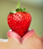 Lips With Strawberry. Stock Images