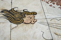 Lisbon, Portugal, August 22, 2018: Fragment of the mosaic of the wind rose. The marble tile shows the face of the wind God. Copy royalty free stock image Lisbon, Portugal, August 22, 2018: Fragment of the mosaic of the wind rose. The marble tile shows the face of the wind God. Copy royalty free stock image