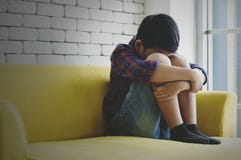 LIttle Asian Boy Sad And Depressed Sitting In The Room Next The Window Royalty Free Stock Photography