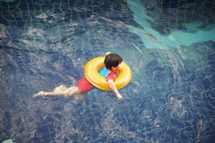 Little boy in the swimming pool with rubber ring stock photo Little boy in the swimming pool with rubber ring stock photo