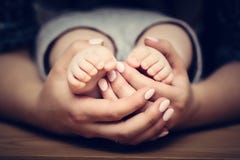 Little baby feet in mother's hands. Child care, feeling safe, protect. Stock Photos Little baby feet in mother's hands. Child care, feeling safe, protect. Stock Photos