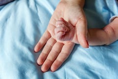 Little baby holding mother`s hand stock photo Little baby holding mother`s hand stock photo