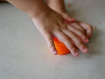 Little baby`s hands closing the plastic box cover, after putting playdough back inside, after finish playing it stock photos Little baby`s hands closing the plastic box cover, after putting playdough back inside, after finish playing it stock photos